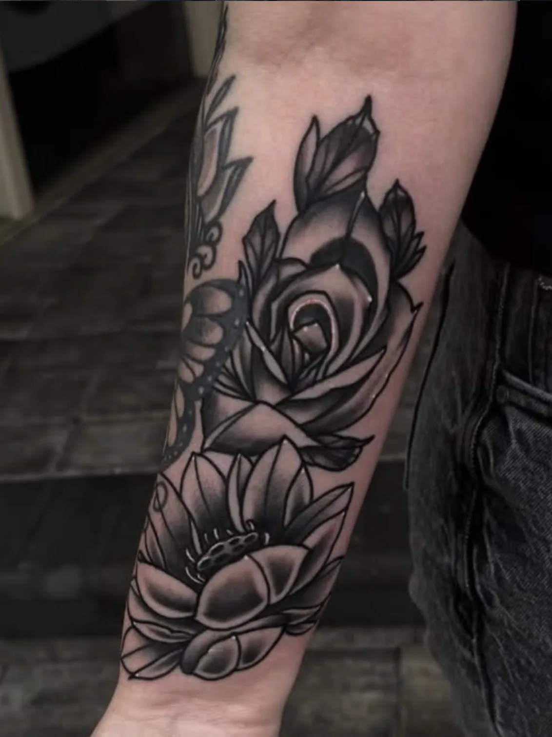 Rose and lotus flower tattoo on arm