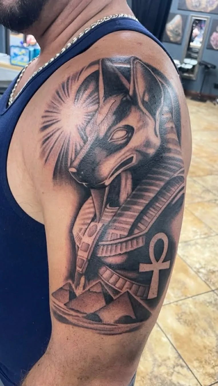 Anubis, pyramids, and ankh tattoo on arm