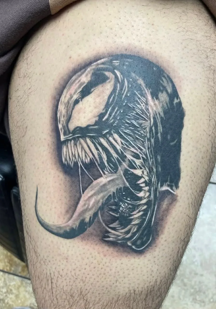 Detailed Venom character tattoo on leg